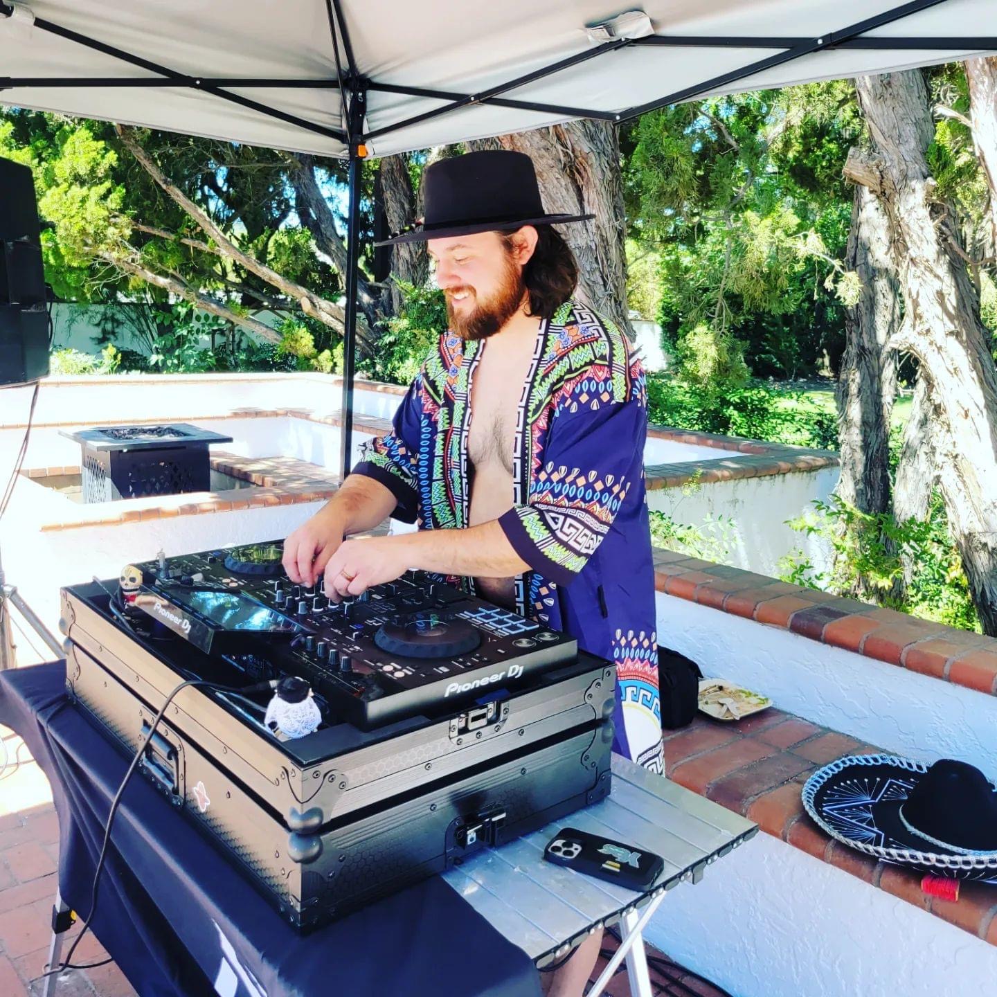 DJ NickNak mixing outdoors at a daytime event